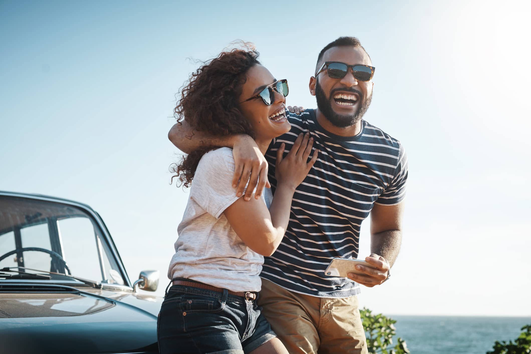 Two allied healthcare professionals laughing outside