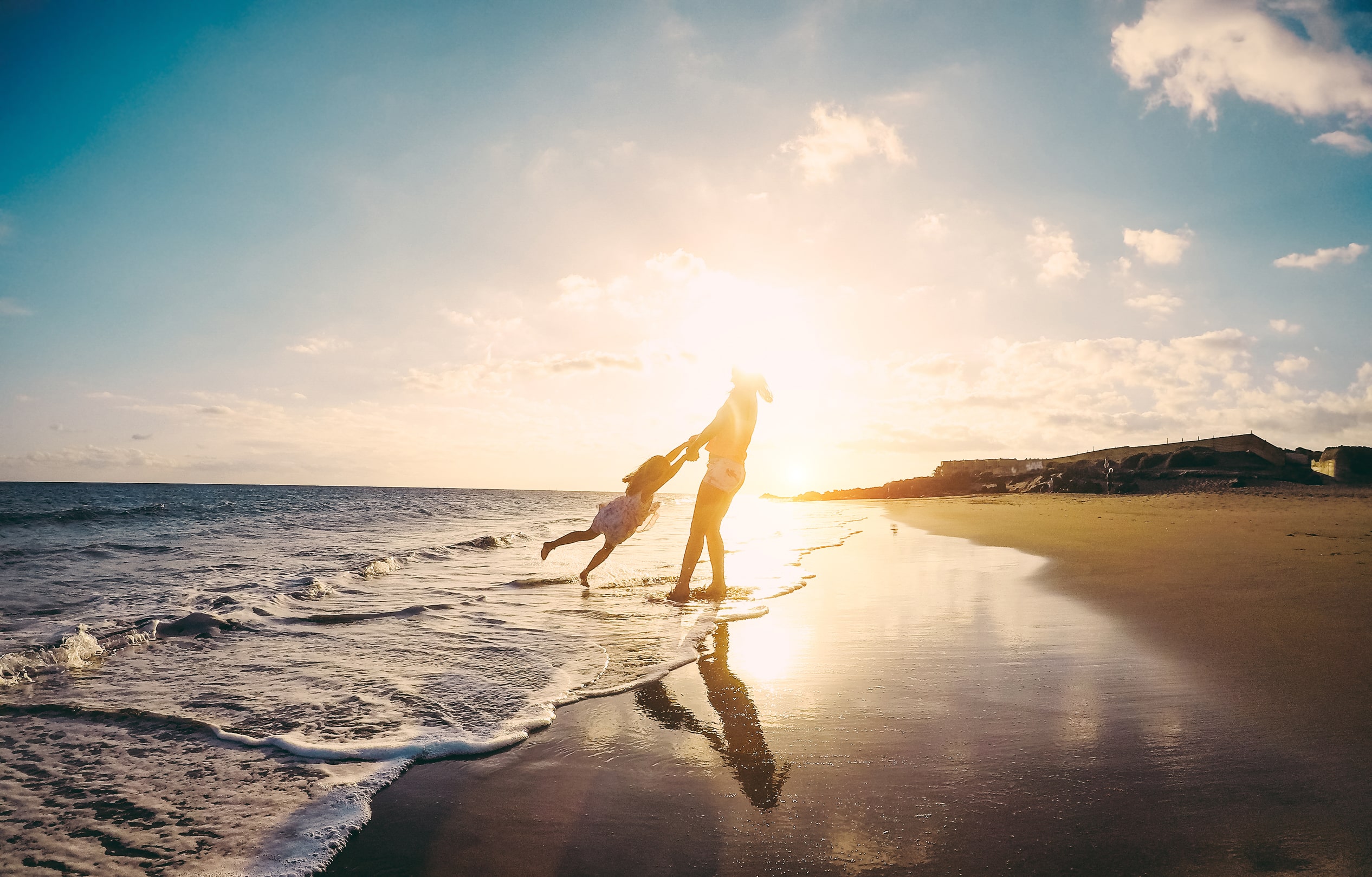 woman and girl playing on california beach at sunset woman and girl playing on california beach at sunset
